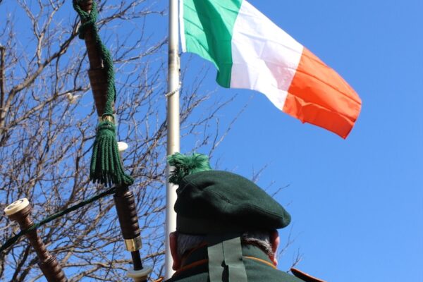 A photograph od a Bagpiper Playing the pipes.