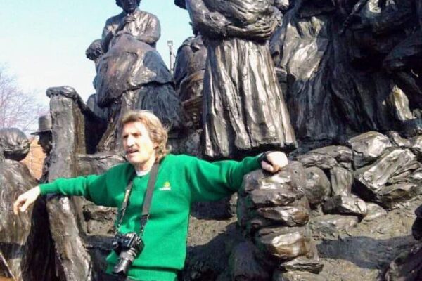 Photographer Tom Keenan leaning against Irish Memorial