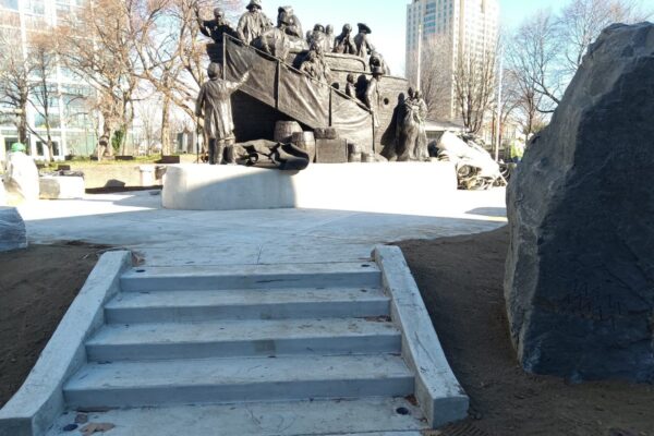 Walking up to a bronze statue of Irish immigrants arriving on a ship