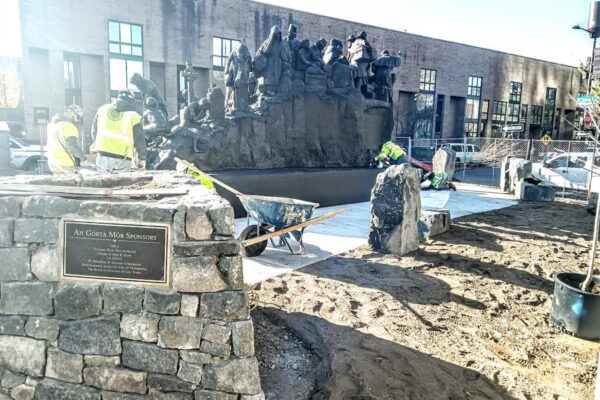 A bronze statue of Irish immigrants arriving on a ship being relocated