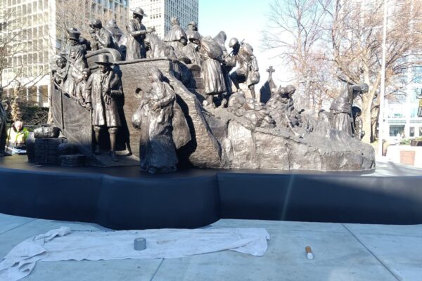 A bronze statue of Irish immigrants arriving on a ship