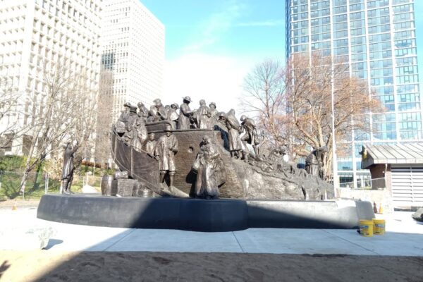 A bronze statue of Irish immigrants arriving on a ship