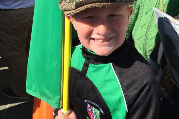Young Irish boy holding the Irish Flag