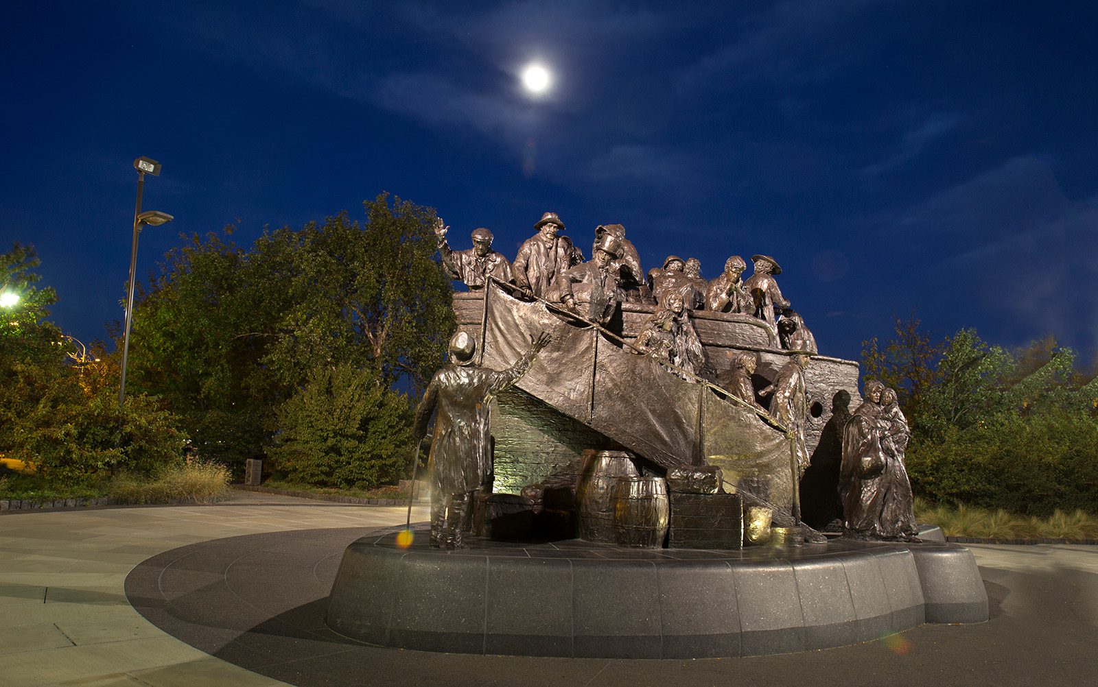 The Irish Memorial under a moonlit sky.